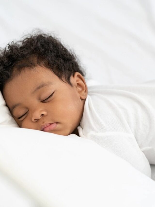 Bebê com roupinha branca dormindo durante sua janela de sono e com ruído branco